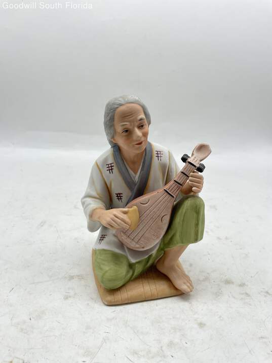 Man With Musical Instrument Figurine image number 1