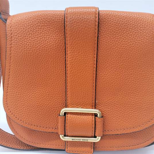 Buy the Michael Kors Maxine Saddlebag Crossbody Bag in Orange