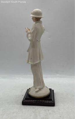 Woman Holding A Dove Figurine alternative image