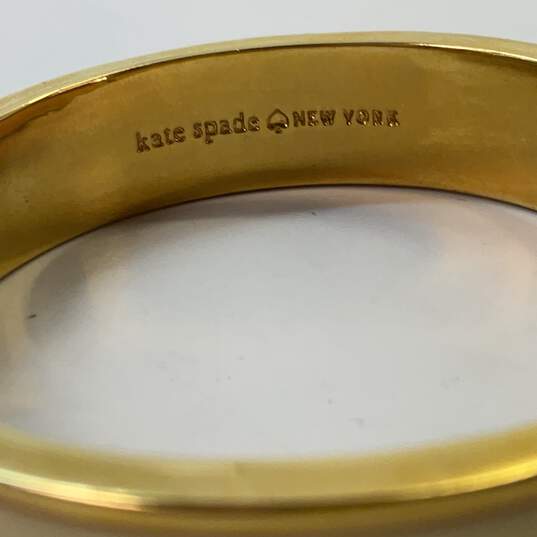 Designer Kate Spade New York Gold-Tone Fold Over Clasp Bangle Bracelet image number 4