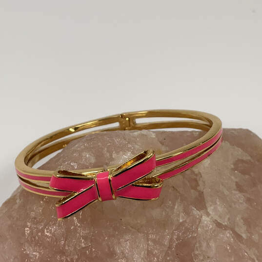Designer Kate Spade Gold-Tone Fashionable Pink Bow Hinged Cuff Bracelet image number 1