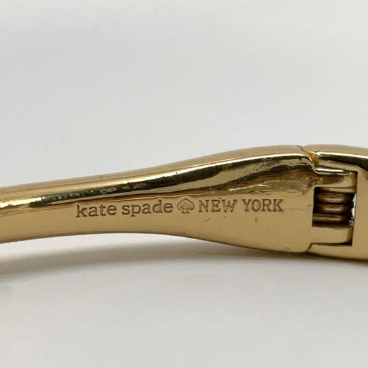Designer Kate Spade Gold-Tone Crystal Stone Hinged Open Cuff Bracelet image number 3
