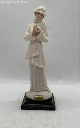 Woman Holding A Dove Figurine