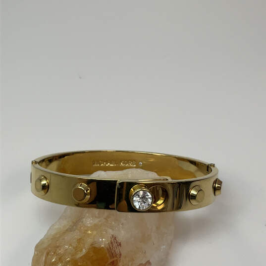 Designer Michael Kors Gold-Tone Fashionable Studded Hinged Bangle Bracelet image number 1
