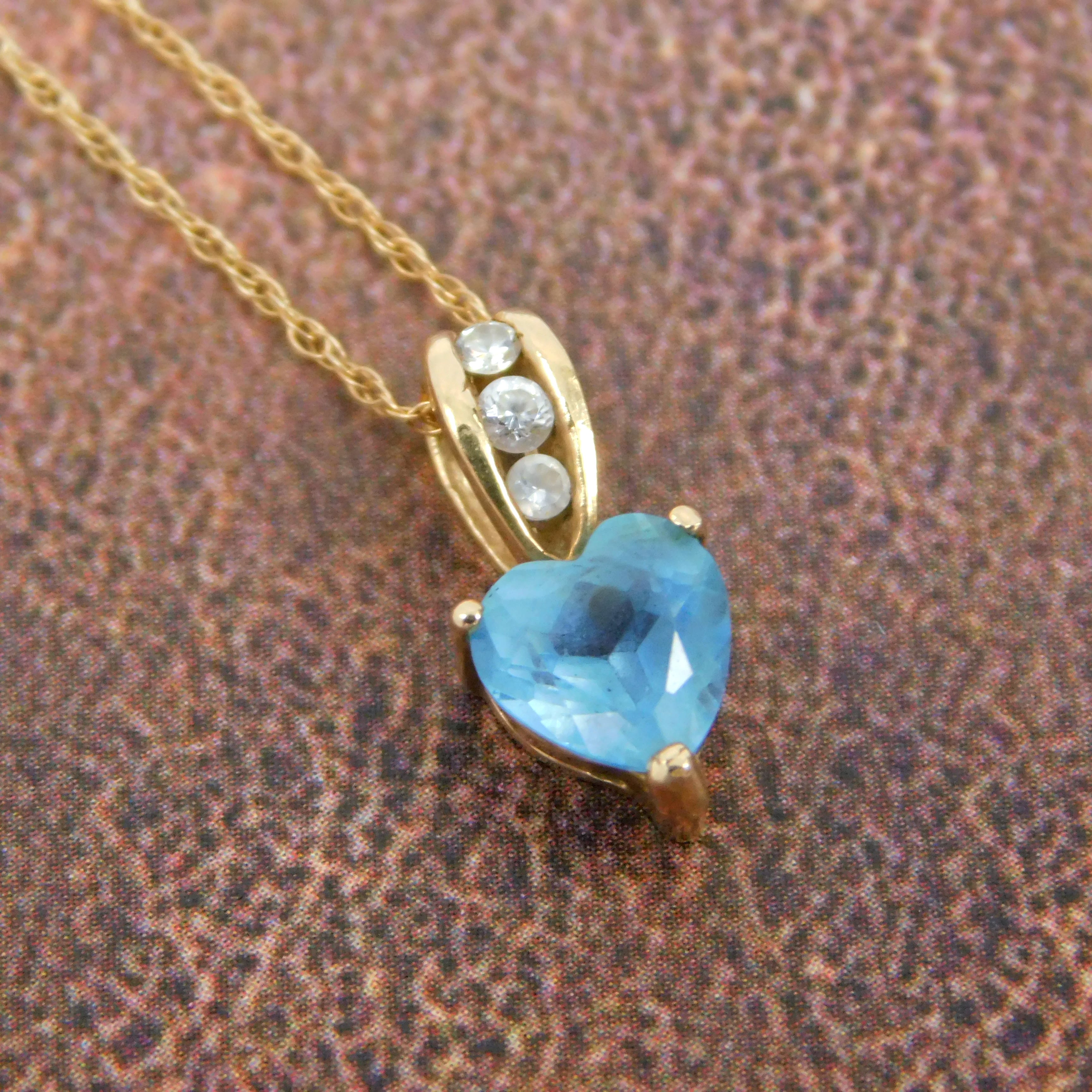 Buy the 10K Yellow Gold Blue Topaz & White Spinel Heart Pendant