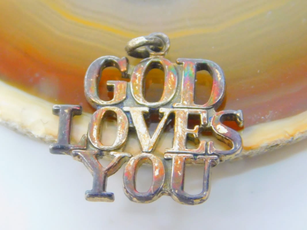 Buy the Tiffany & Co. Sterling Silver God Loves You Charm Pendant