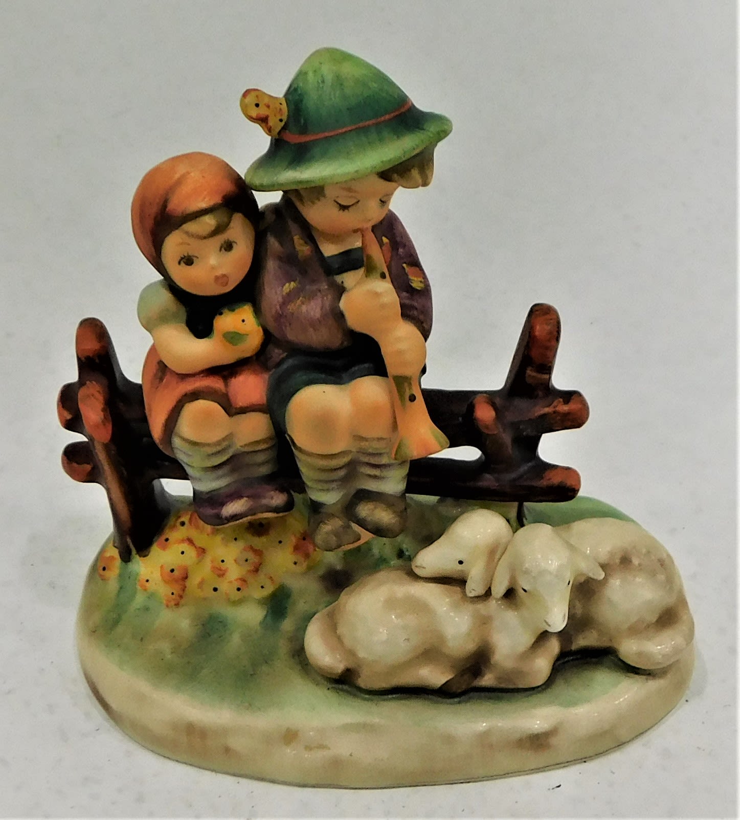 Buy the Goebel MJ Hummel Boy And Girl Sitting On Fence With Sheep ...